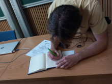 student signing the Q-Camp journal